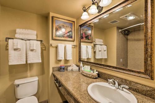 a bathroom with a sink and a toilet and a mirror at Crested Butte Studio with Community Hot Tub and Pool! in Crested Butte