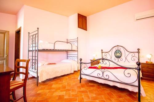 a bedroom with two bunk beds and a table at Agriturismo Poggio Pistolese in Montaione