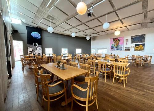une salle à manger avec des tables et des chaises en bois dans l'établissement Sunderby folkhögskola Hotell & Konferens, à Luleå