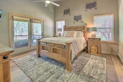 a bedroom with a bed and a dresser and windows at Deck, Grill and Fire Pit Spacious Show Low Hideaway in Show Low