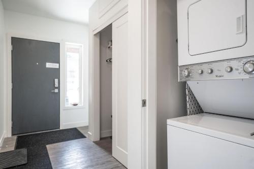 a kitchen with a white stove top oven next to a door at RendezView by Revelstoke Vacations in Revelstoke