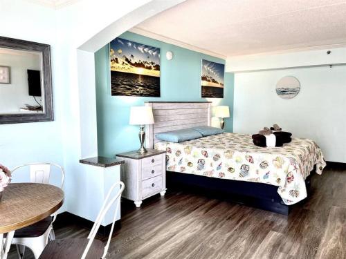 a bedroom with a bed and a table and a table at *BEACH, COMFY, SUNNY* *Great Pools, Hot Tubs, Lazy Rive & More*S44 in Myrtle Beach