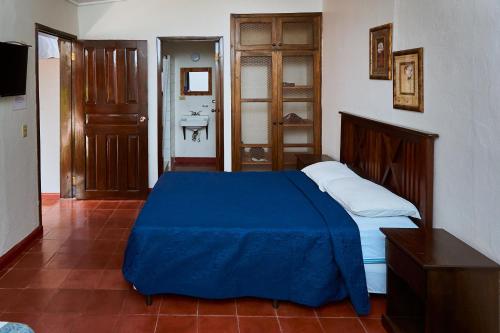 Un pat sau paturi într-o cameră la La Posada Copan