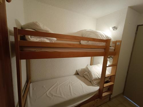 a couple of bunk beds in a room at auris en oisans, vue sur le massif des ecrins in Auris