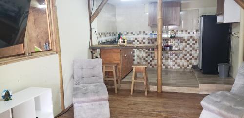 una cucina con tavolo e sedie in una stanza di Cabaña los Naranjos con parqueo a Calarcá