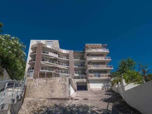 a tall apartment building in front of a blue sky at Seaview Couple Studio with pool-Przno in Pržno