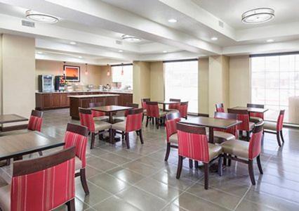 a dining room with tables and chairs and a cafeteria at Comfort Inn Midland South I-20 in Midland