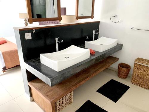 a bathroom with two sinks on a black counter at Elegant Villa in Grand Baie with Pool in Grand Baie