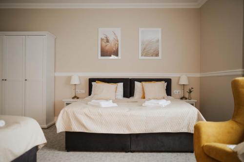 a bedroom with a bed with two towels on it at Villa Adele in Polanica-Zdrój