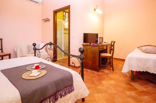 a room with two beds and a table with a bowl of fruit at Agriturismo Poggio Pistolese in Montaione