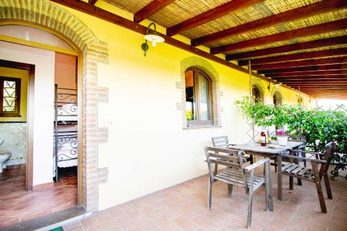 a patio with a table and chairs on a house at Agriturismo Poggio Pistolese in Montaione