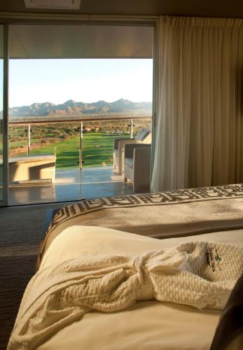 a bedroom with a bed and a large window at Talking Stick Resort in Scottsdale