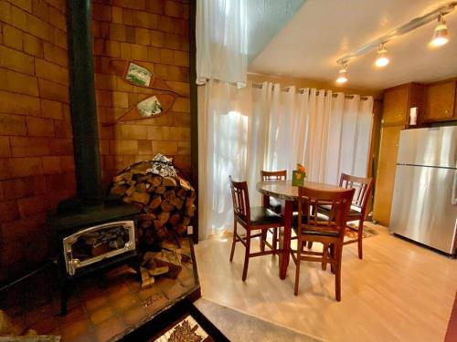 a dining room with a table and a fireplace at Mammoth Awesome Location-1 min to Shuttles & Food in Mammoth Lakes