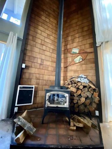 a fireplace in a room with a pile of wood at Mammoth Awesome Location-1 min to Shuttles & Food! TOML-CPAN-11402 in Mammoth Lakes