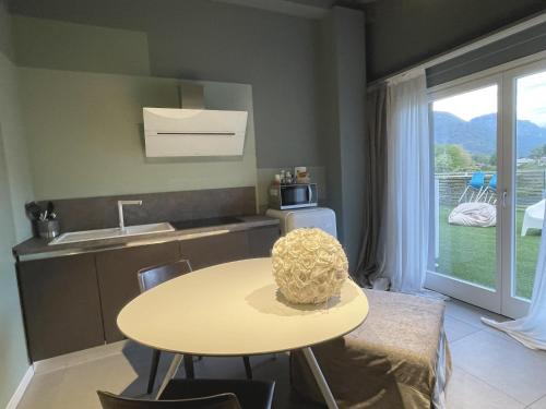 a small kitchen with a table and a sink at Art B&B Design in Costa Volpino