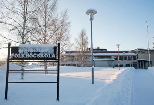 a sign in the snow next to a street light at Sunderby folkhögskola Hotell & Konferens in Luleå