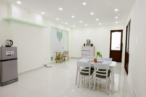 a kitchen and dining room with a table and chairs at LáVuTa Home in Vung Tau