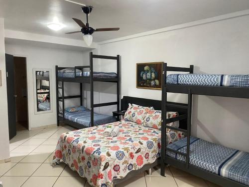 a room with four bunk beds and a bed at Ipanema Club Hostel in Rio de Janeiro