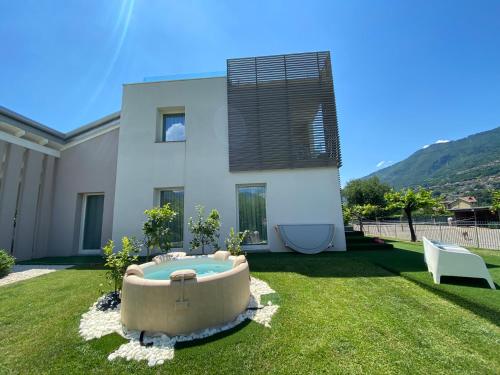 a house with a bath tub in the yard at Art B&B Design in Costa Volpino