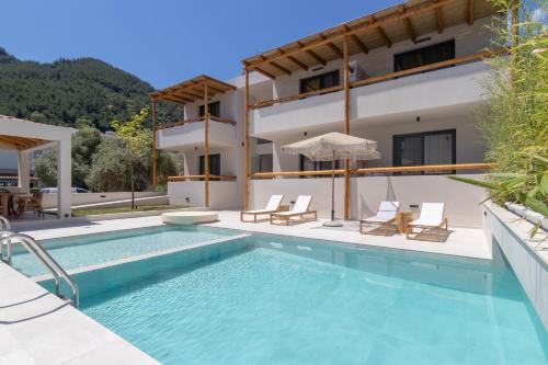 a villa with a swimming pool and a house at Rastoni - Relax & Retreat in Skala Potamias
