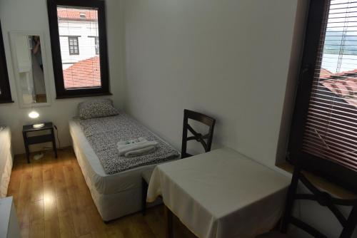 a room with a bed and a table and chairs at Jovanovic Guest House in Ohrid