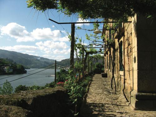 a narrow street with a view of a river at Casa de Rebolfe (Cinfães - Douro) in Cinfães