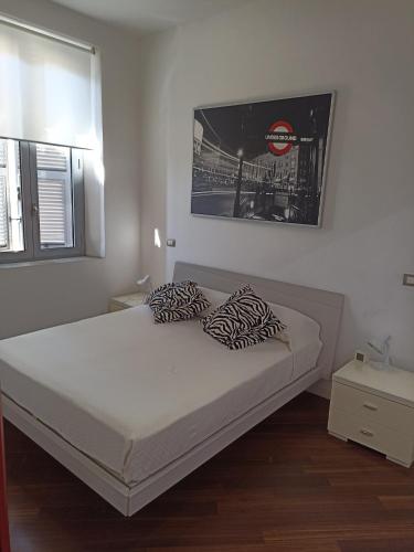 a bedroom with a bed with zebra pillows on it at Attico Gabriel in Civitavecchia