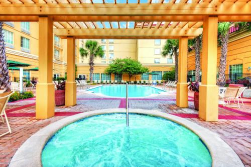 a hot tub in a courtyard with a pergola at La Quinta Inn & Suites by Wyndham San Antonio Riverwalk in San Antonio