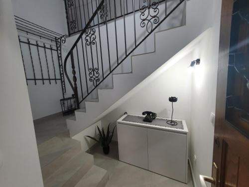 a staircase with a table and a stair railing at Apartman Stela in Korčula