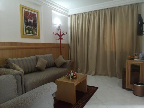 a living room with a couch and a table at Majliss Hotel Downtown in Rabat