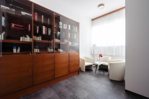 a living room with a wooden cabinet and a table at Landhotel Freitag in Sankt Paul im Lavanttal