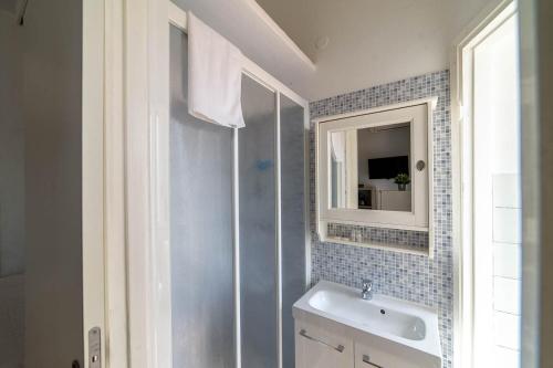 a bathroom with a sink and a mirror at Hbhall Residenze Darsena in Milan