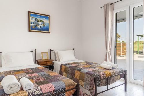 Posteľ alebo postele v izbe v ubytovaní Villa Rosa South Corfu