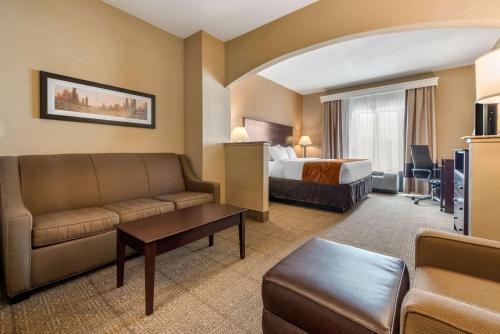 a hotel room with a bed and a couch at Comfort Suites near Route 66 in Springfield