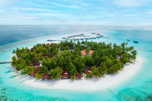 an island in the ocean with a resort on it at Diamonds Athuruga Maldives Resort & Spa in Athuruga Island