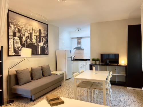 a living room with a couch and a table at Apartamentos Caspe in Caspe