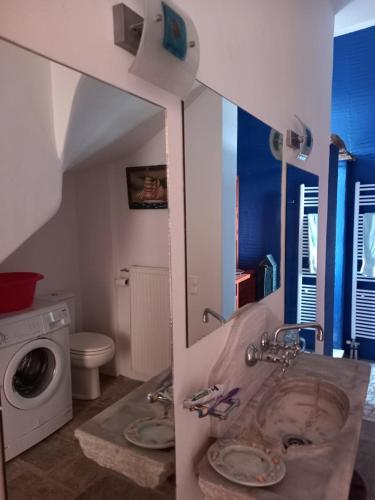a bathroom with a sink and a washing machine at ArtHome0A in Panormos