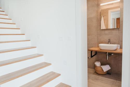 a bathroom with a staircase and a sink at High View House in Okrug Donji