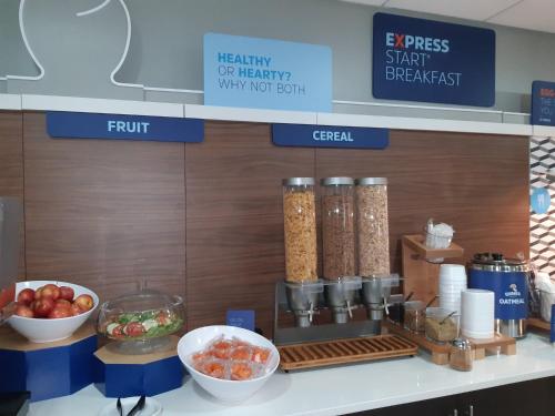 a counter with some bowls of food on it at Holiday Inn Express Trincity by IHG in Piarco