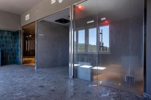 a glass elevator in a building with a window at Hotel Del Lago Piediluco Active & SPA in Piediluco