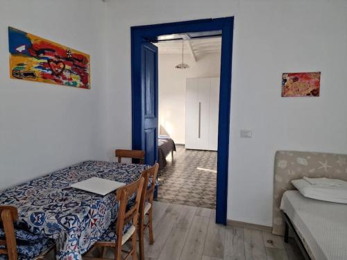a room with a table and a room with a bed at Stromboli Vacanze in Stromboli