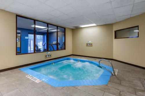 a large swimming pool in a room with a large window at Comfort Inn & Suites SW Houston Sugarland in Houston