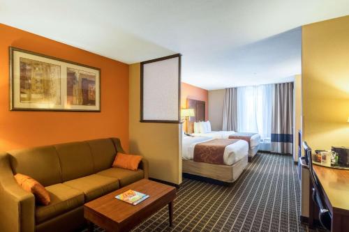 a hotel room with a couch and a bed at Comfort Suites in Panama City Beach