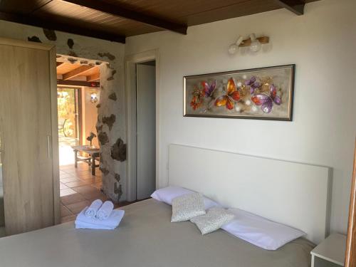 a bedroom with a bed and a painting on the wall at Hotel Rural la Correa del Almendro ONLY ADULTS in Arona