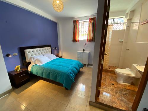 a blue bedroom with a bed and a toilet at BROTHERs HOUSE in Cusco