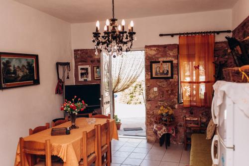 a dining room with a table and a window at HILL SANDALI HOUSE in Sitia