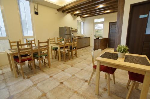 a kitchen and dining room with tables and chairs at 輕旅小站 Soft Travel Hostel in Taitung City