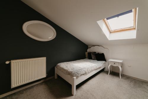 a small bedroom with a bed and a mirror at Meteor Central in Cluj-Napoca