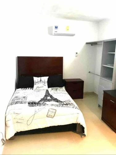 a bedroom with a large bed with a wooden headboard at Departamento hermoso en guadalupe in Monterrey