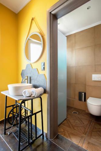 a bathroom with a sink and a mirror at CONTE CRISTO Suites in Paralia Katerinis